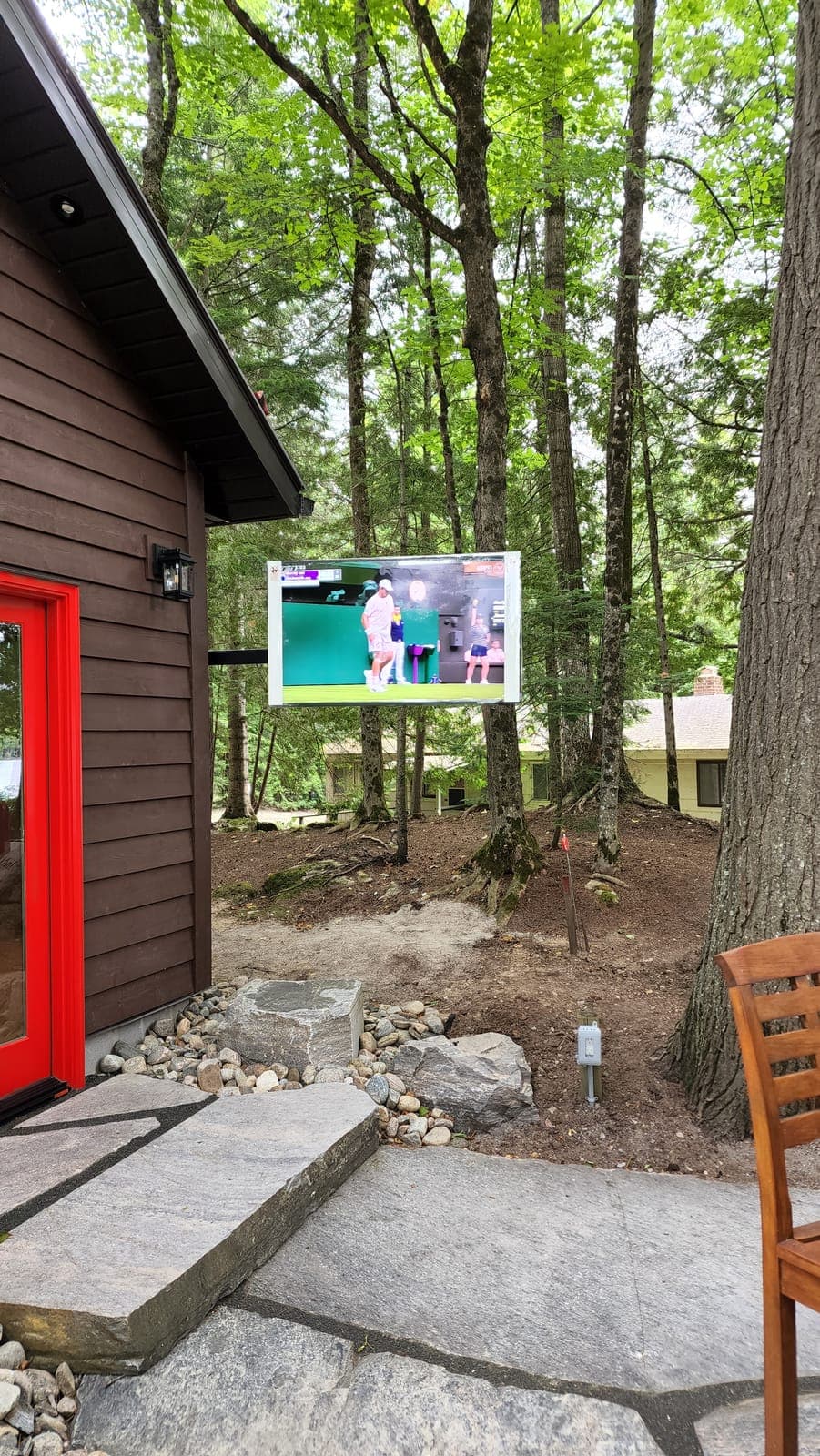 Weatherproof outdoor TV wall mount at a cottage