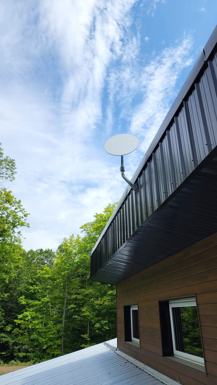 Starlink dish on a clean eave mount at a modern home